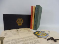 An AA blue rectangular lidded box, containing a Hotel Handbook 1939-40, a Garage Handbook, a copy of