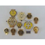 A quantity of early style AA lapel badges.