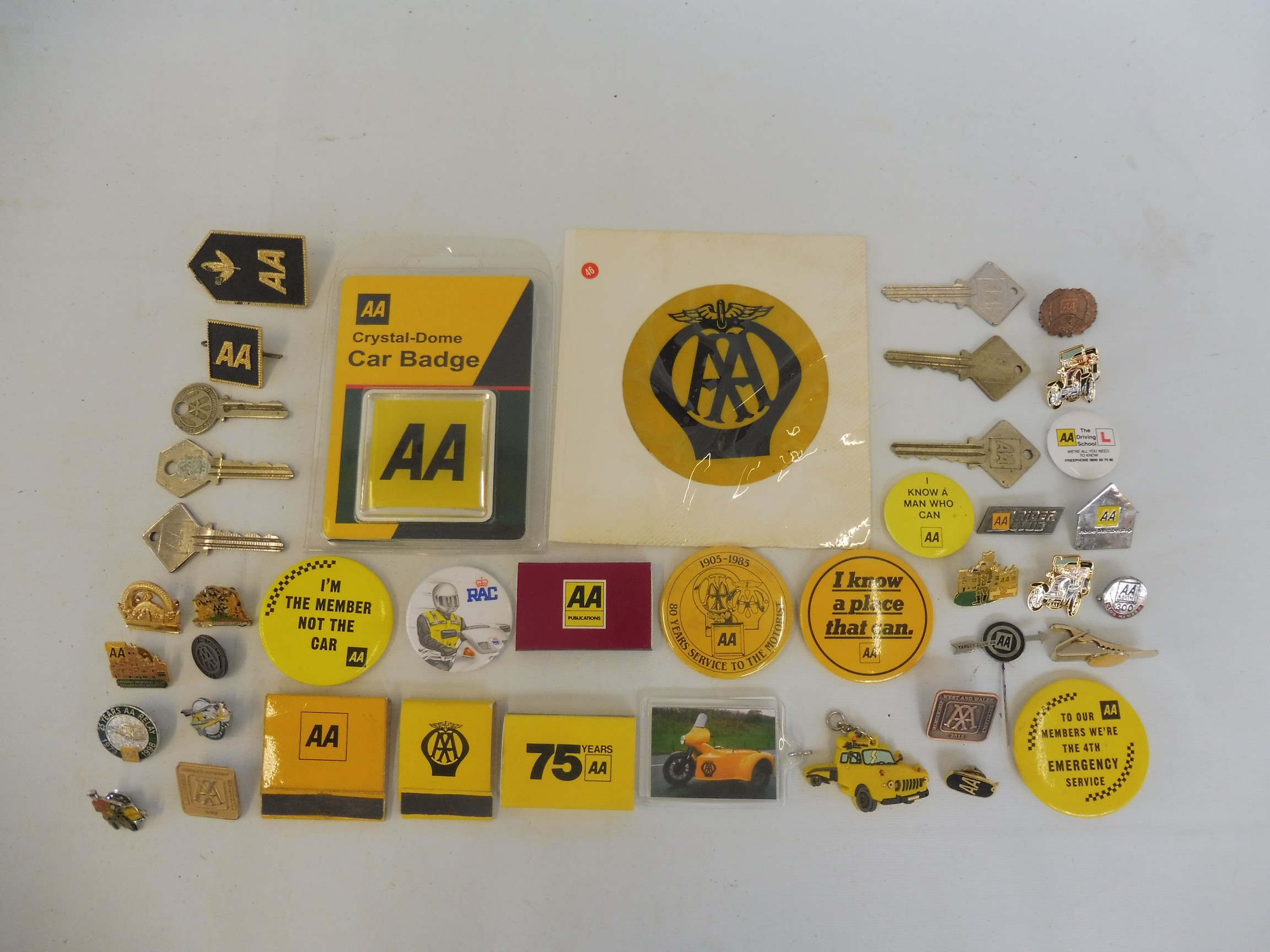 A selection of AA badges, enamel and plastic, AA keys, an early plastic window badge etc.