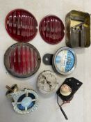 Three original red glass pork pie lamp lenses, a Smiths oil pressure gauge, a tin of letter/number