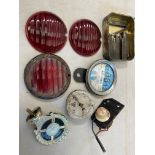 Three original red glass pork pie lamp lenses, a Smiths oil pressure gauge, a tin of letter/number