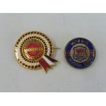 A Morris BMC enamel rosette lapel badge plus a Morris Universal Service badge.