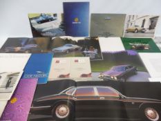 A Jaguar E Type road test plus various Jaguar and Daimler car brochures.