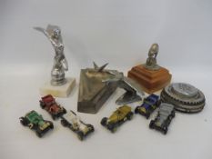 Three assorted car mascots, a post-war Vauxhall desktop ashtray, a Rolls-Royce wheel centre plus a