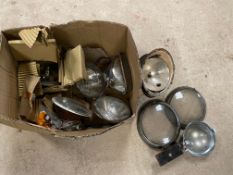 A box of lamps, sealed beam including VW Beetle lenses and shells.