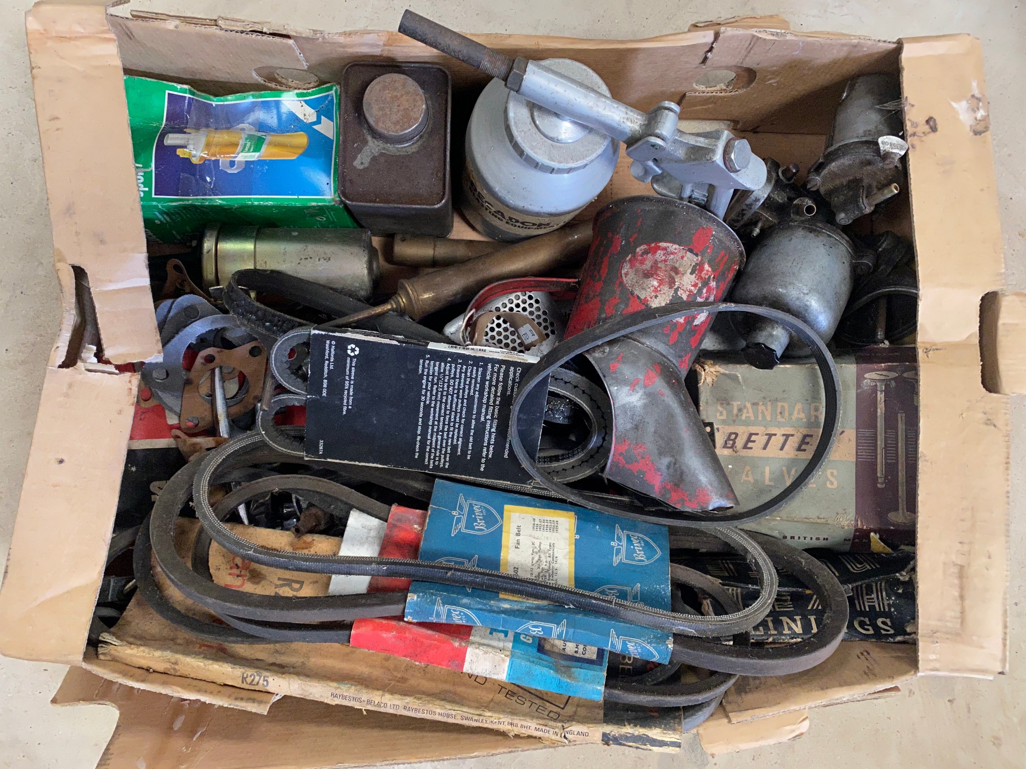 A box of tools and car parts.