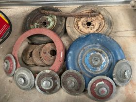A collection of Alvis 14hp parts to include six hubcaps, two wheels, spare wheel covers, brake drums