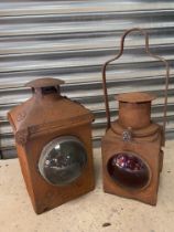 Two railway lamps with bullseye lenses, one stamped 'Brie'.