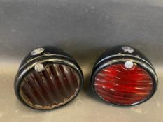 Two Lucas ST38A pork pie rear lights, both with good black enamel and glass lenses.