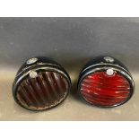 Two Lucas ST38A pork pie rear lights, both with good black enamel and glass lenses.