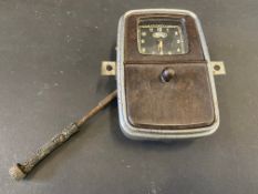 A Smiths clock movement, with Ford branding to the dial, with integral fold-down bakelite ashtray.