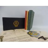 An AA blue rectangular lidded box, containing a Hotel Handbook 1939-40, a Garage Handbook, a copy of