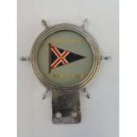 A Royal Motor Yacht Club car badge.