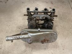 A pair of Stromberg carburettors on a manifold with an intake.