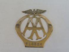 An unusually thin AA badge, possibly motorcycle, nickel, no. 718336.