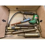 A box of grease guns plus a Castrol oil measure.