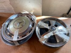 A set of four Rover 3500S hubcaps plus four Mercedes W123 hub caps.