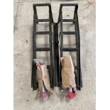 A pair of car ramps and a pair of new folding axle stands.