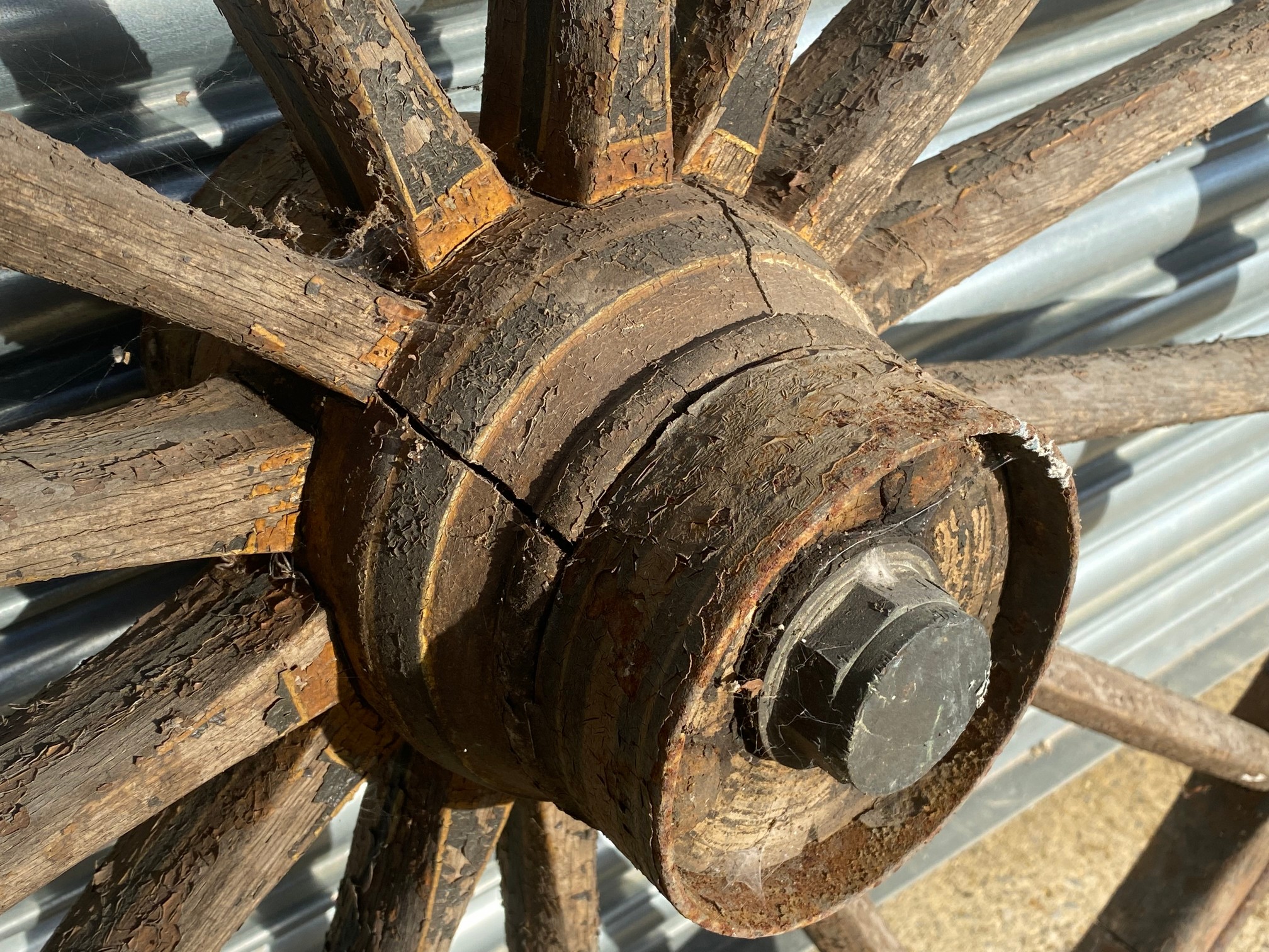 A large wooden and metal rimmed cart wheel with traces of original paint. - Image 2 of 4