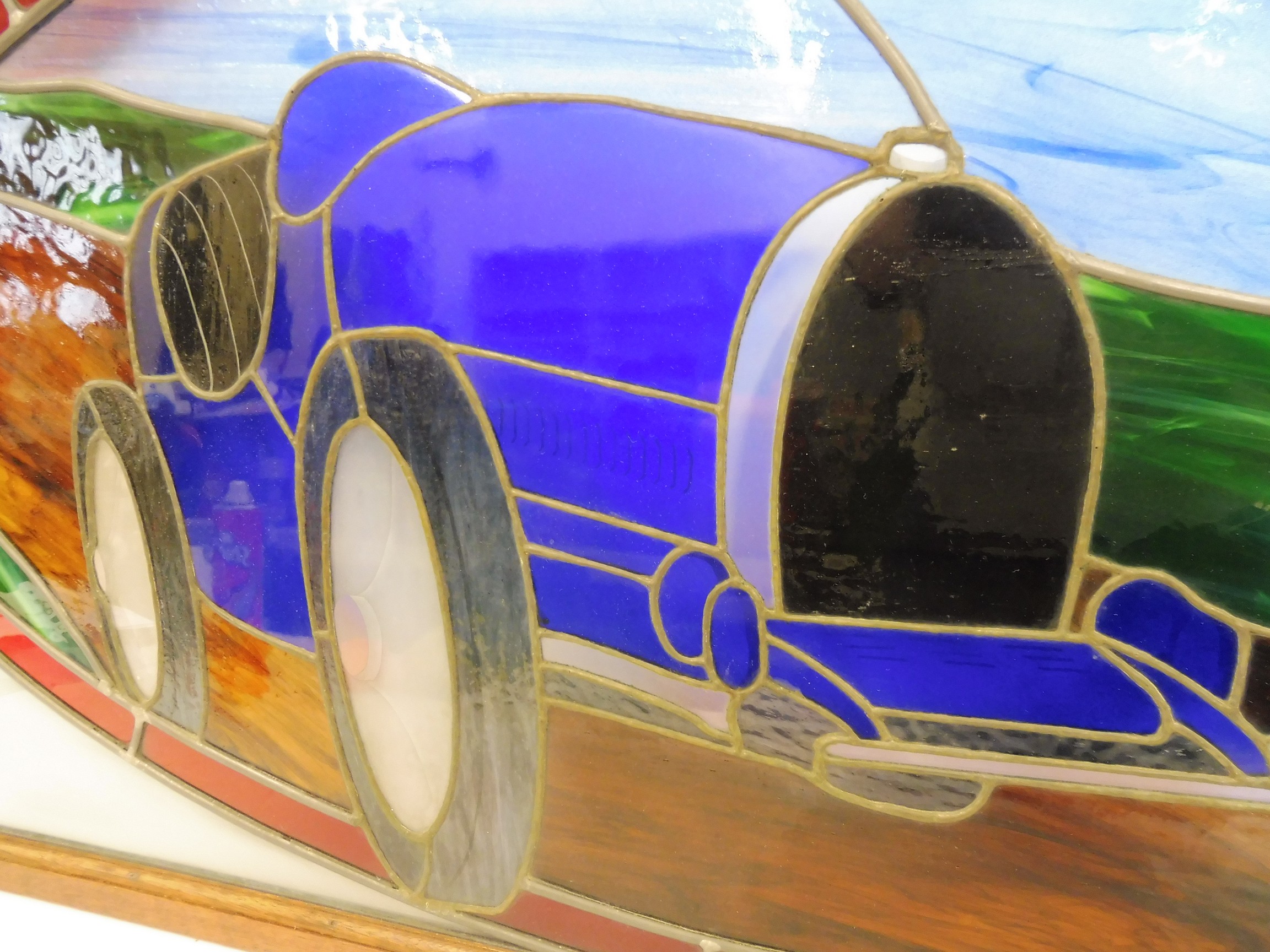 J. RAINEY - a stained glass panel showing a Bugatti Type 35, in a wooden frame, 47 1/2 x 23 1/2". - Image 2 of 3