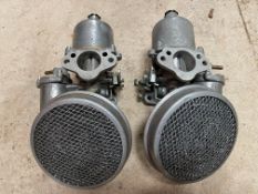 A pair of SU carburettors plus pancake filters.