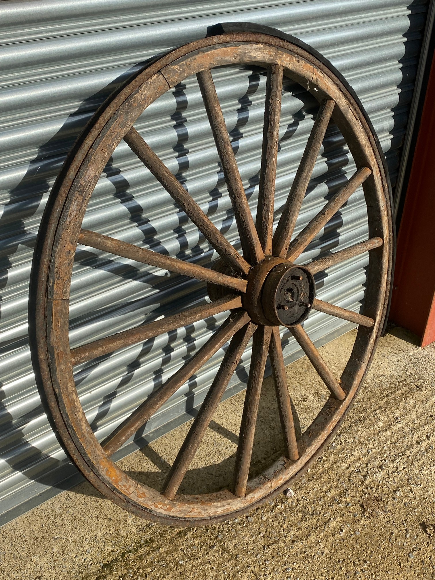 A large wooden and metal rimmed cart wheel with traces of original paint. - Image 3 of 4