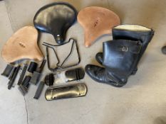 A collection of Indian motorcycle spares comprising three saddles, two being new tan