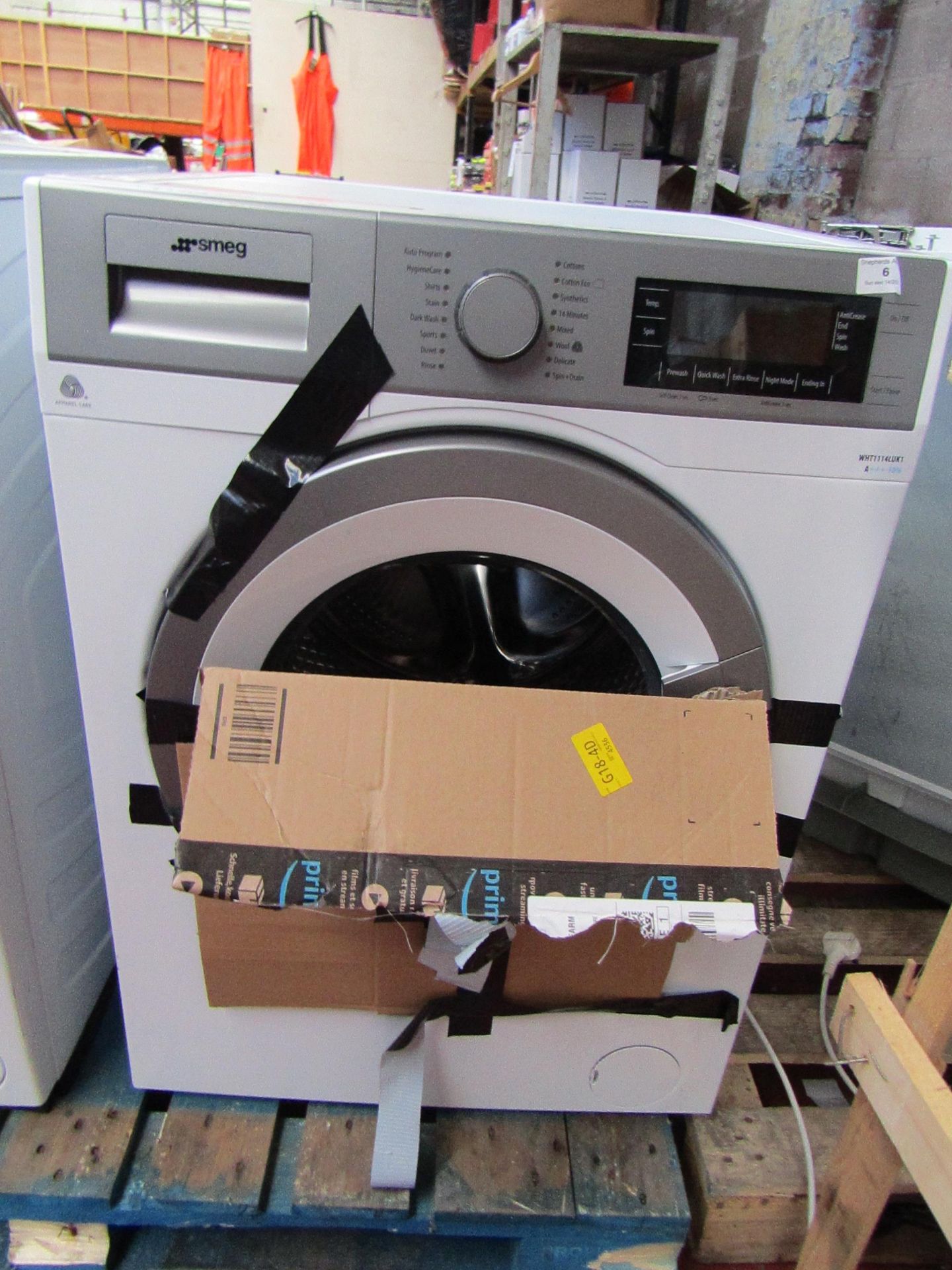 Smeg WHT1114LUK1 washing machine, powers on but not tested any functions due to smashed glass.