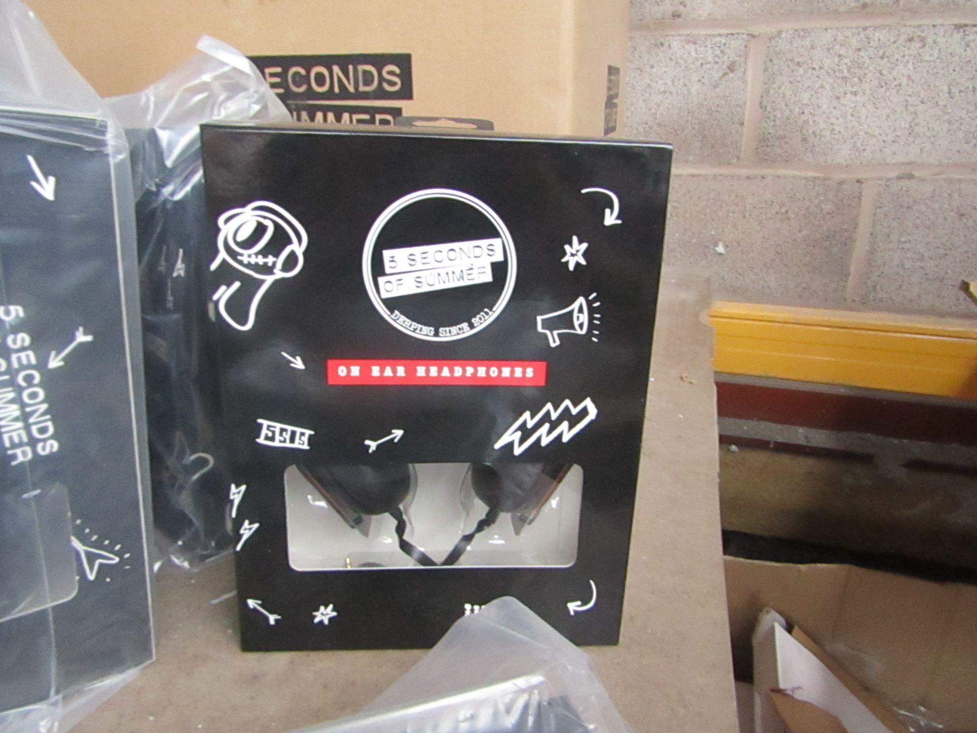 20x 5 Seconds of Summer headphones, new and boxed.