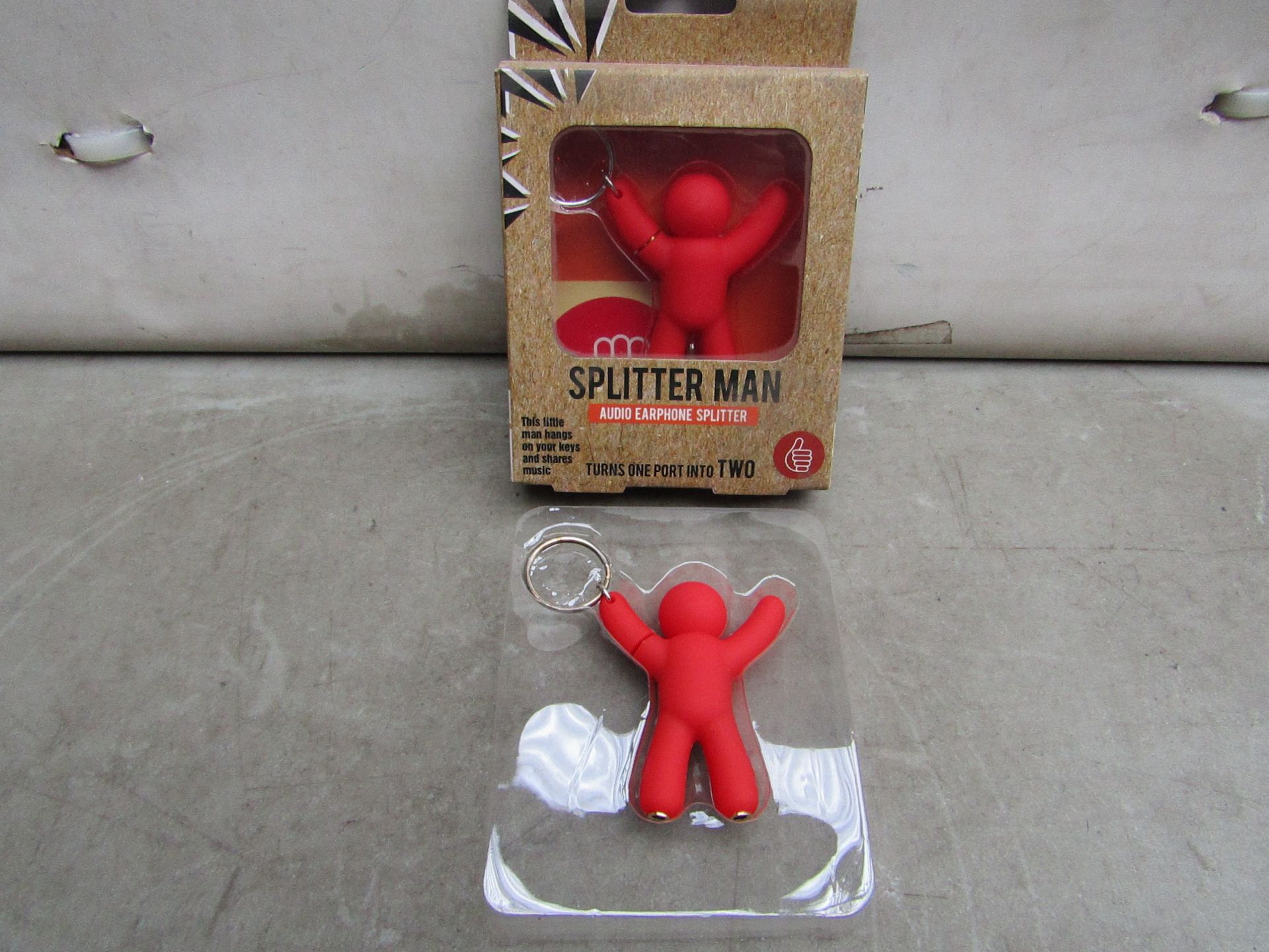 Box of 24x Splitter man Key Rings, enables aux cable to be shared into a device while being store on