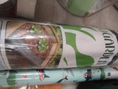 2 items being a roll of weed fabric control 8mtrs x 1mtr, new and a roll of Xmas gift wrap.
