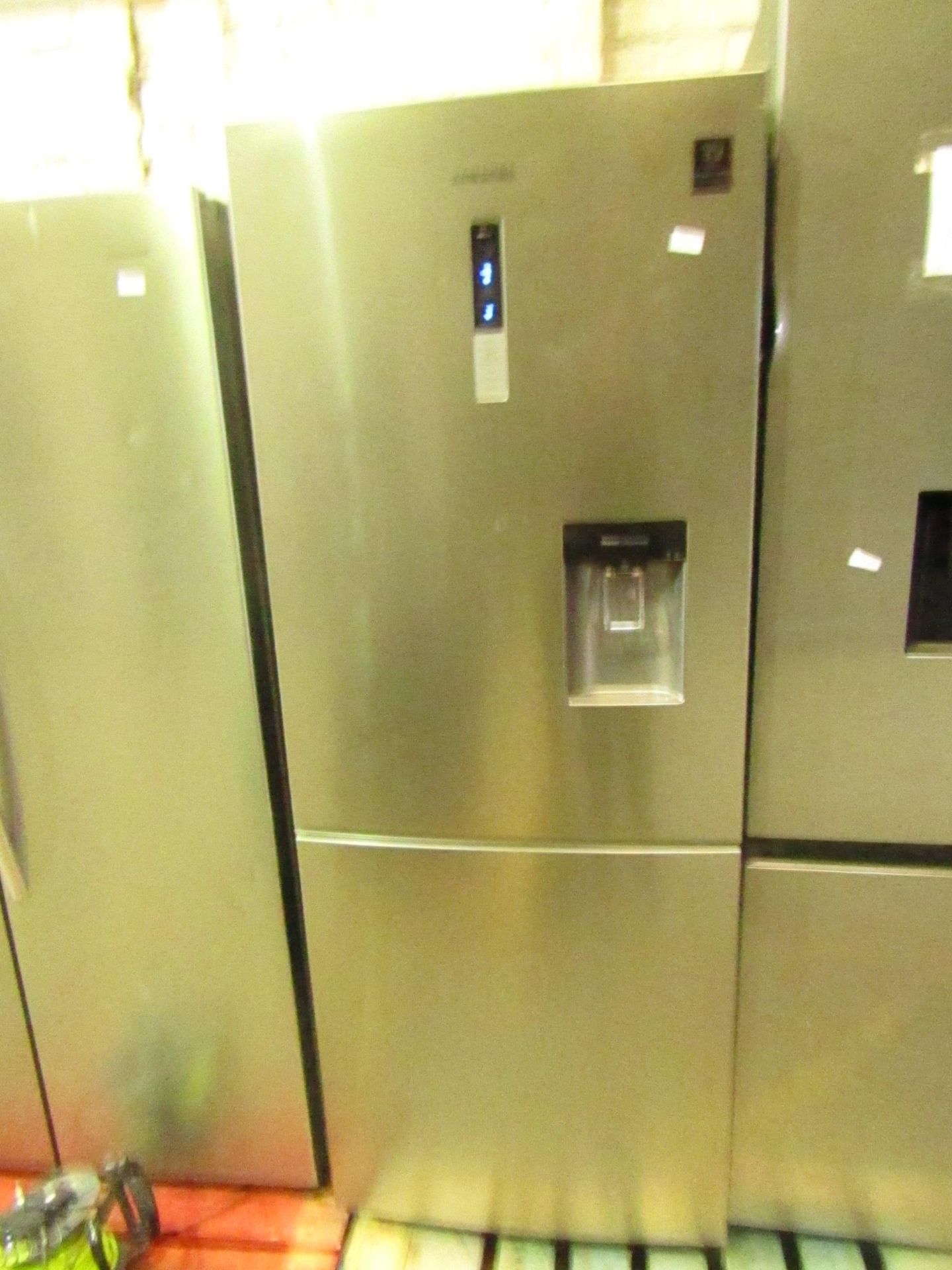 Samsung RL4363SBASL 60/40 fridge freezer with water dispenser built in, has a small dent on the