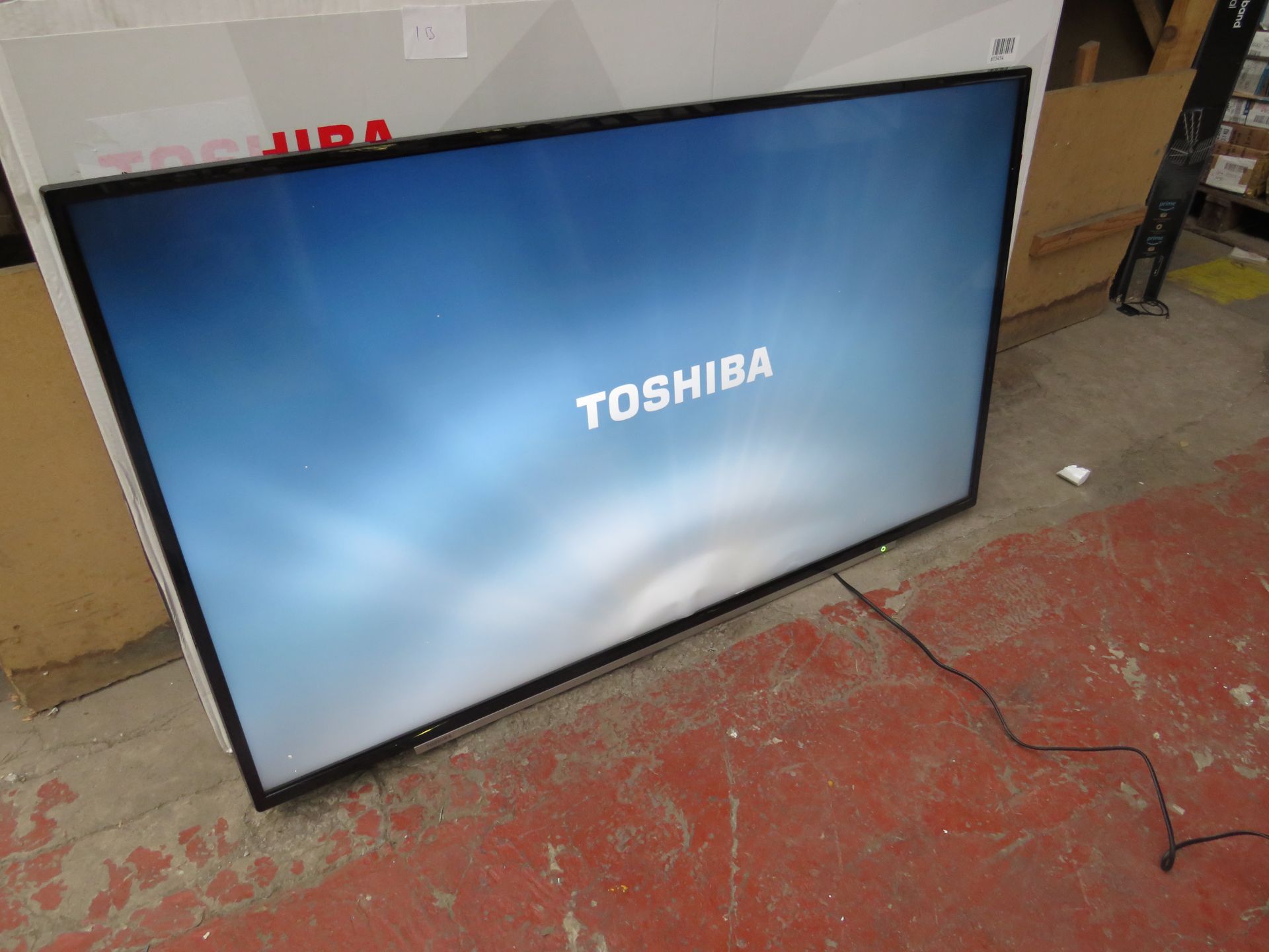 Toshiba 55" 4K HDR TV, tested working but display showing it has a bent near the bottom. No stand.