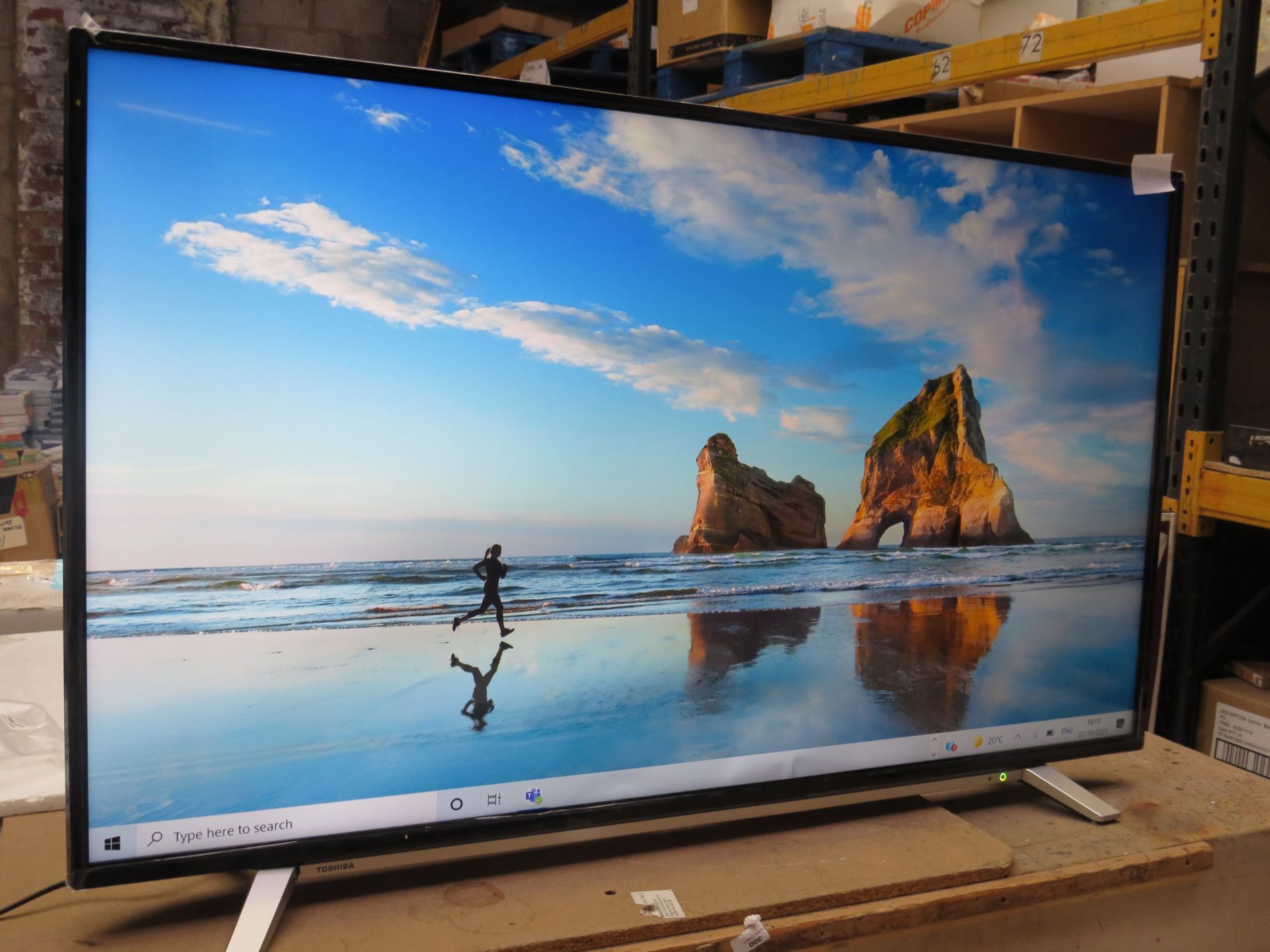 Toshiba 55" 4K HDR TV, tested working but display showing it has a bent near the bottom. Includes