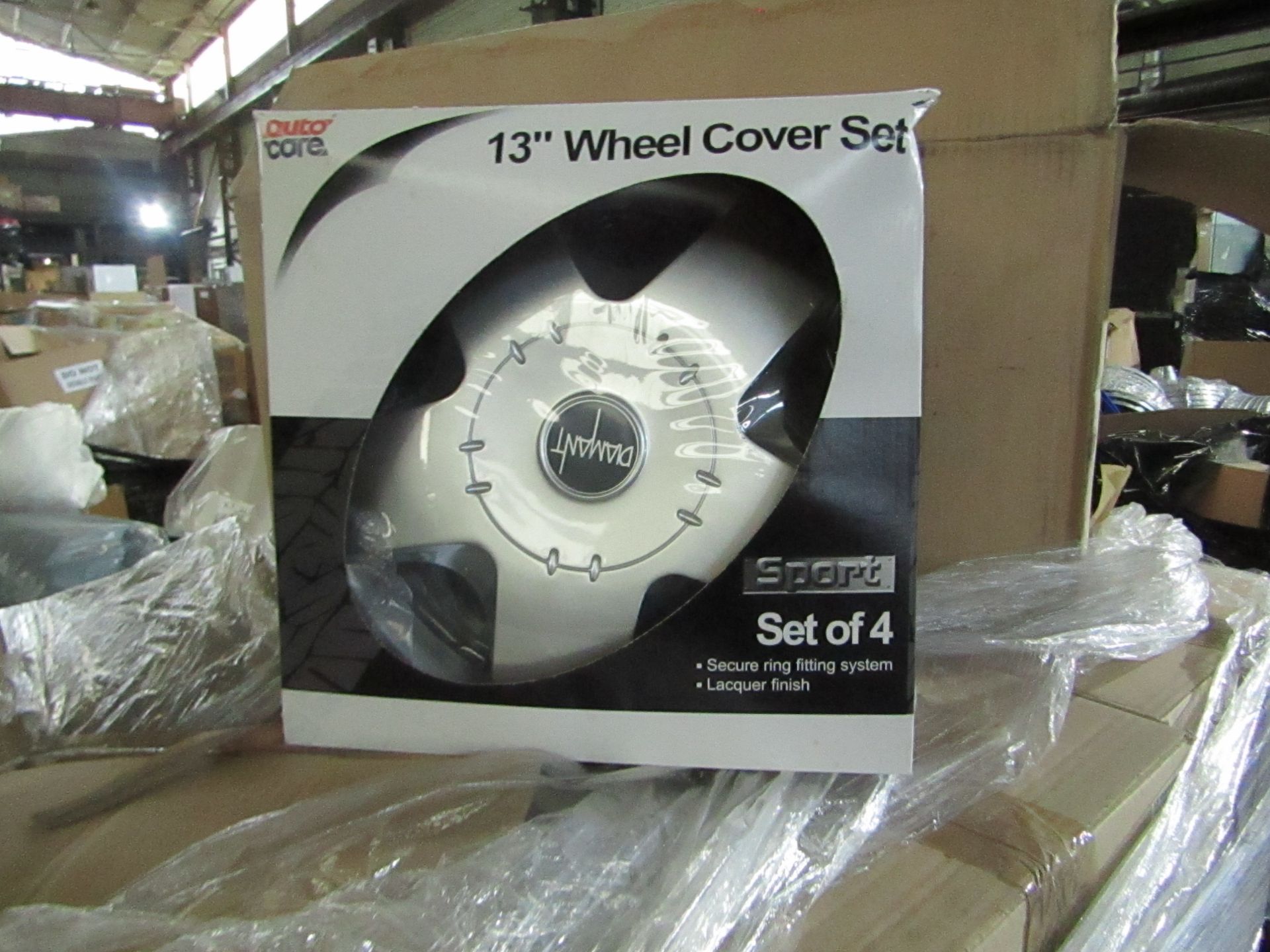 APPROX 36 PACKS OF 4 13" WHEEL COVERS. UNUSED AND PACKAGED