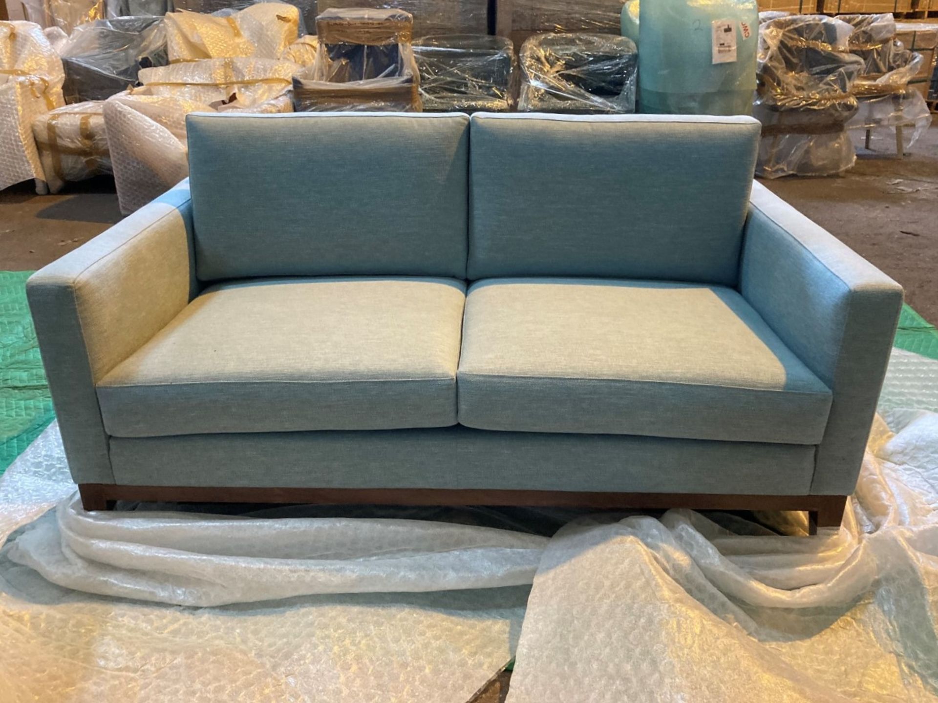 Light blue upholstered two seater sofa