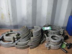 Quantity of various size pipe re-rounding clamps