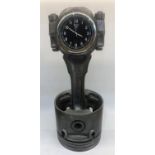 A piston clock desk piece formed from a Land Rover V8 piston