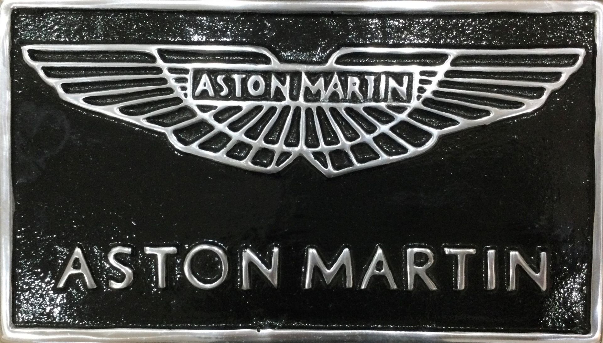 A Contemporary Black Painted Cast Aluminium Aston Martin Themed Wall Sign