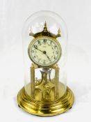 Brass anniversary clock under a glass dome, by Kieninger & Obergfell