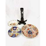 Oriental shallow dish, a very decorative carved wooden plate stand, and 2 other plates
