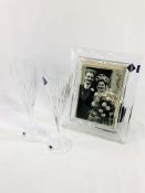 Two Edinburgh Crystal champagne flutes, boxed; together with an Edinburgh Crystal photograph frame.