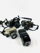 Three Minolta SLR cameras.