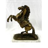 Brass coloured model of a rearing horse, on a marble base