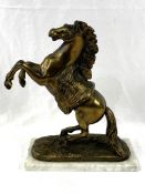 Brass coloured model of a rearing horse, on a marble base