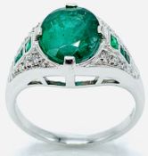 18ct white gold emerald ring with emeralds and diamonds to shoulder.