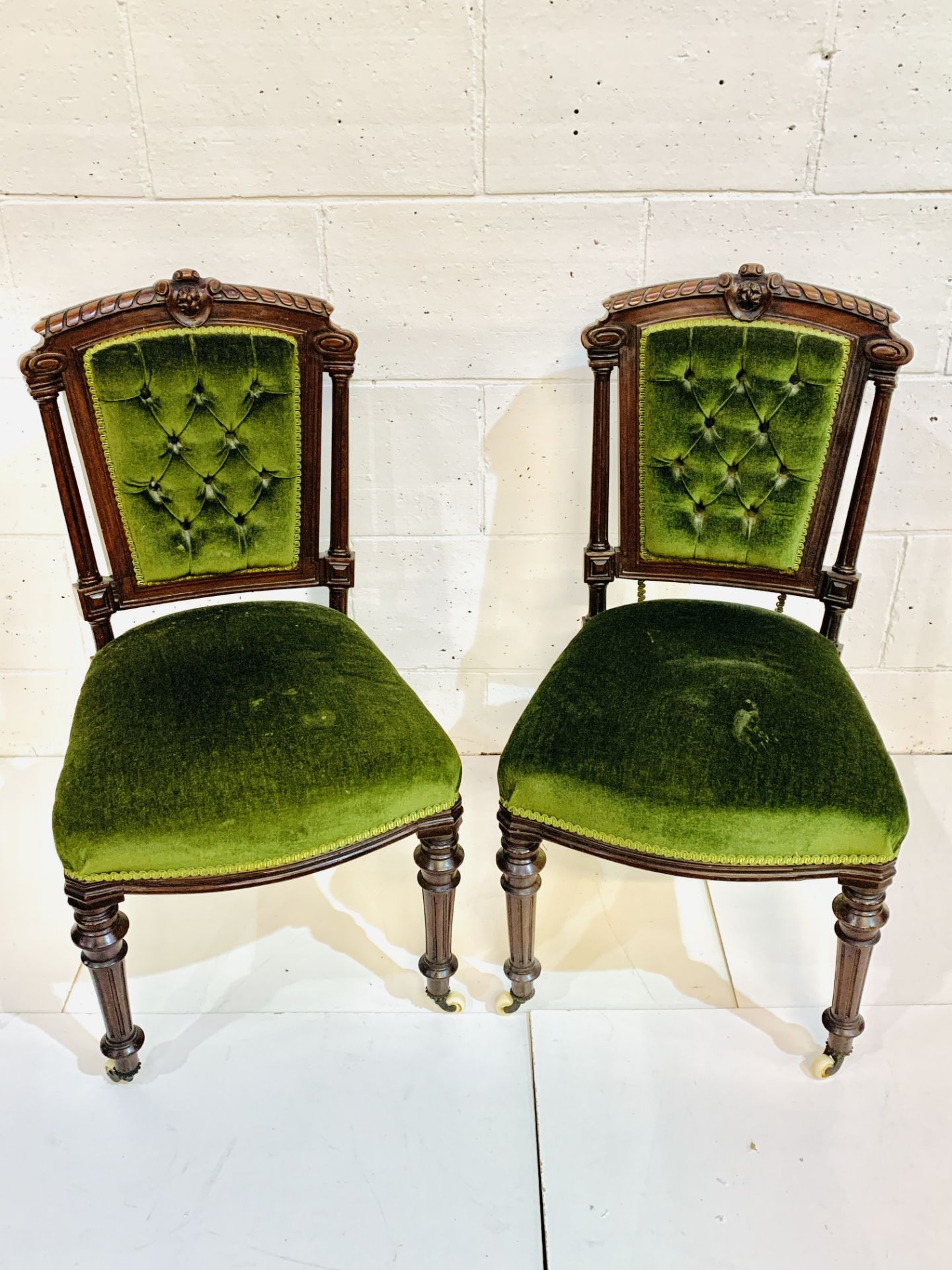 A pair of mahogany framed column sided dining chairs.