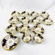 Eleven blue and gold hand painted Coalport cups and saucers