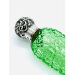 Late Victorian green cut glass perfume flask with a silver lid.