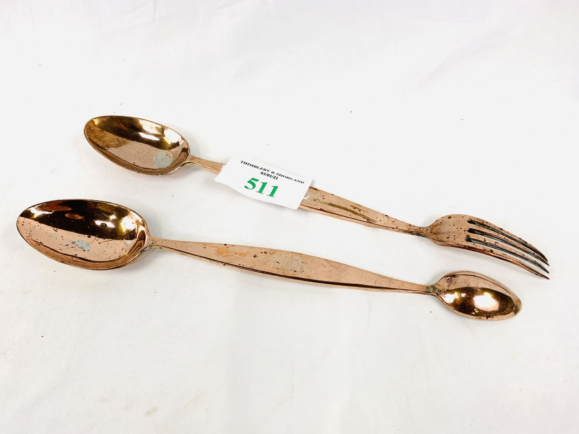 Two copper Benham and Son's serving utensils, marked with a crown and initials RY.
